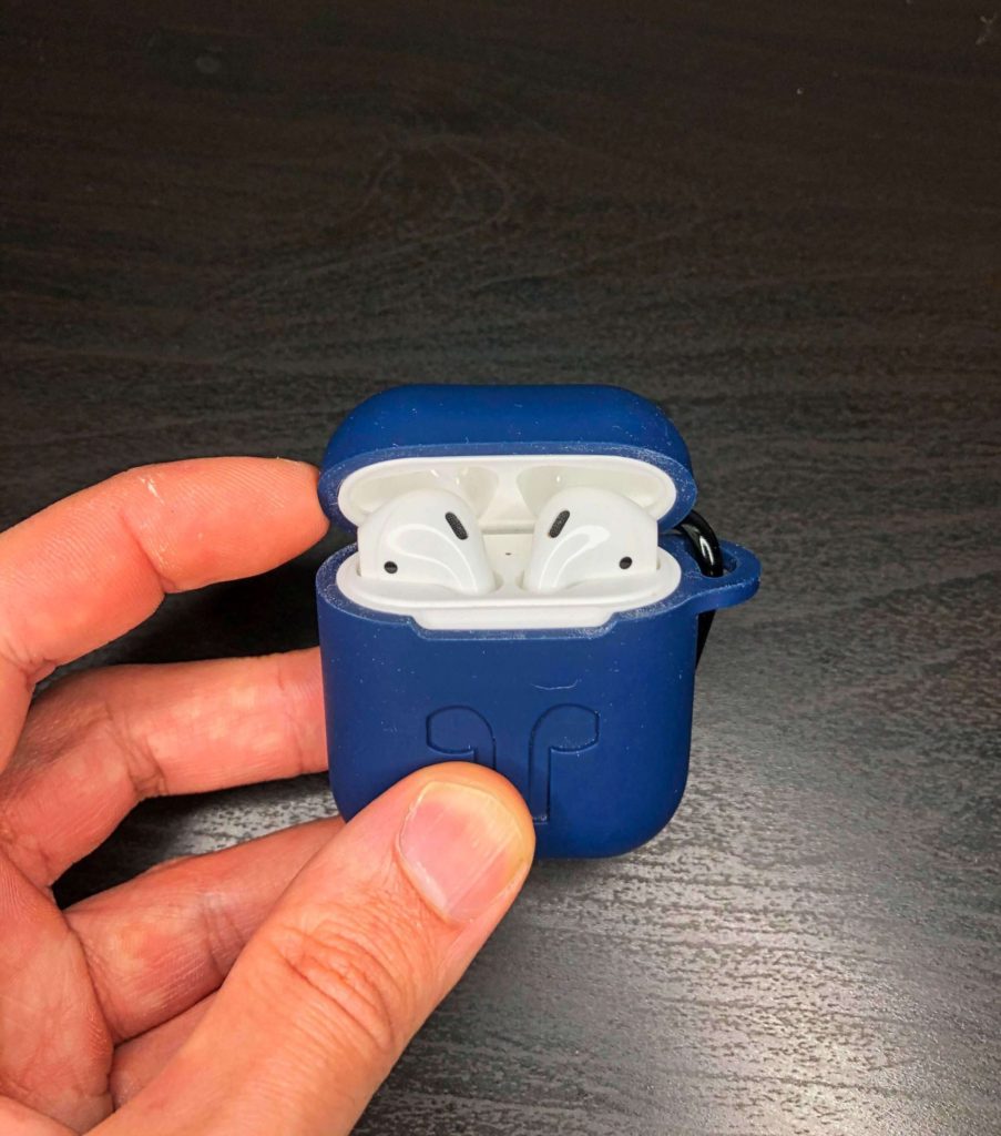 AirPods in a blue silicone case with the lid open