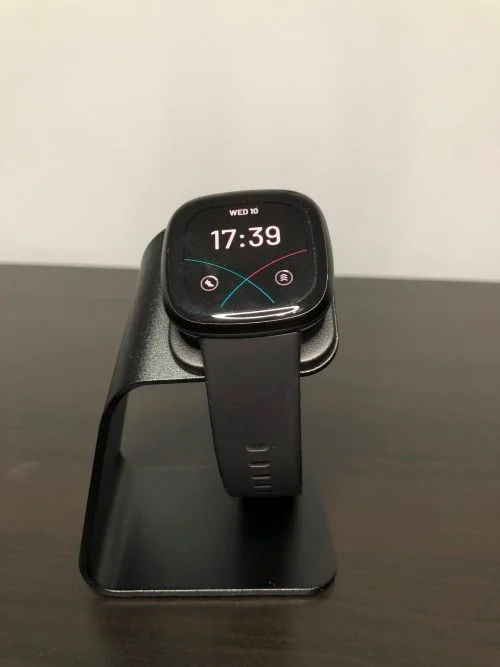 The Fitbit Versa 3 on the KIMILAR charger dock