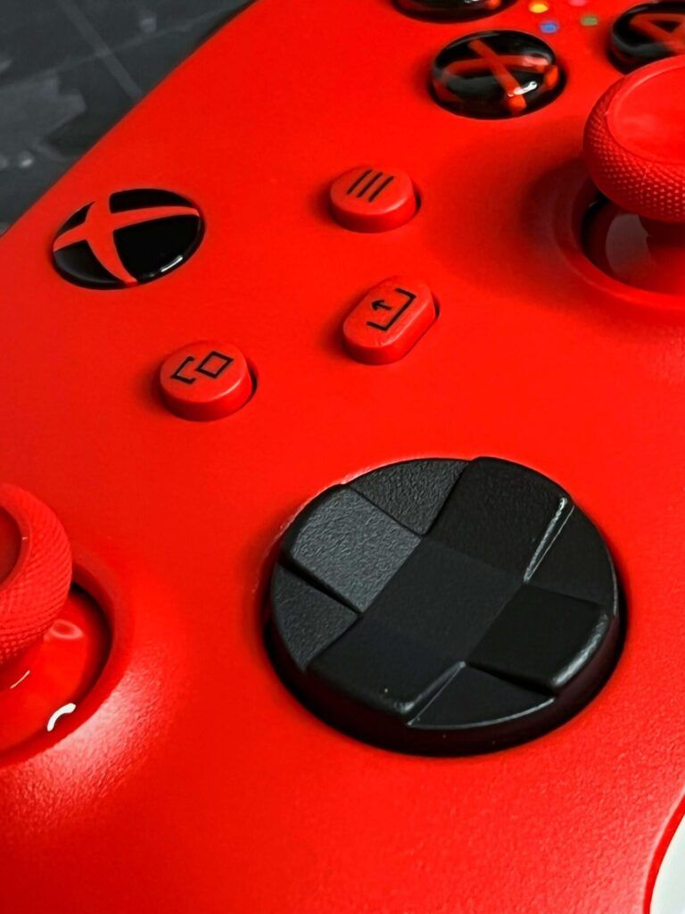 A close up of the D pad on the Xbox pulse red controller